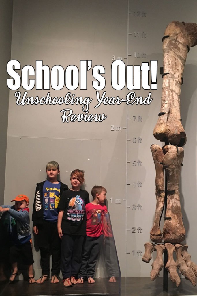 4 boys of different heights stand beside a size chart and a very large fossil of the leg and foot bones from a dinosaur. School's Out! It is summer and we are excited for warmer weather and new adventures. We just had our unschooling year-end meeting and are officially done!